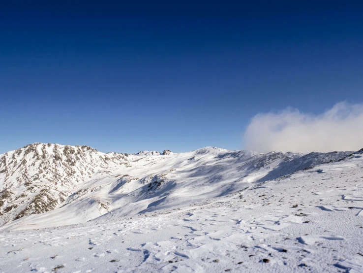 an image of a snowy mountains with a skier on the left