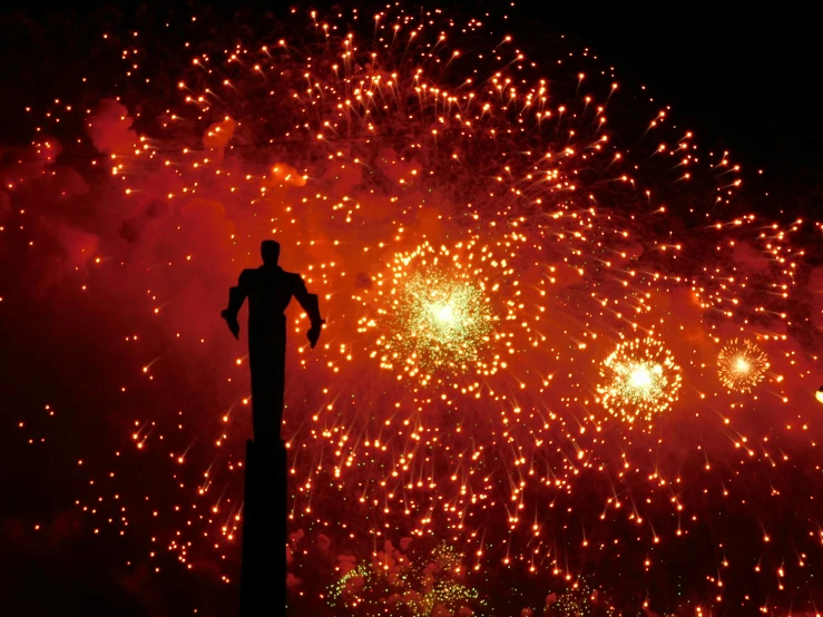 a person on top of a pole that is fireworks