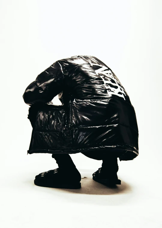 a man is wrapped up in a big plastic bag