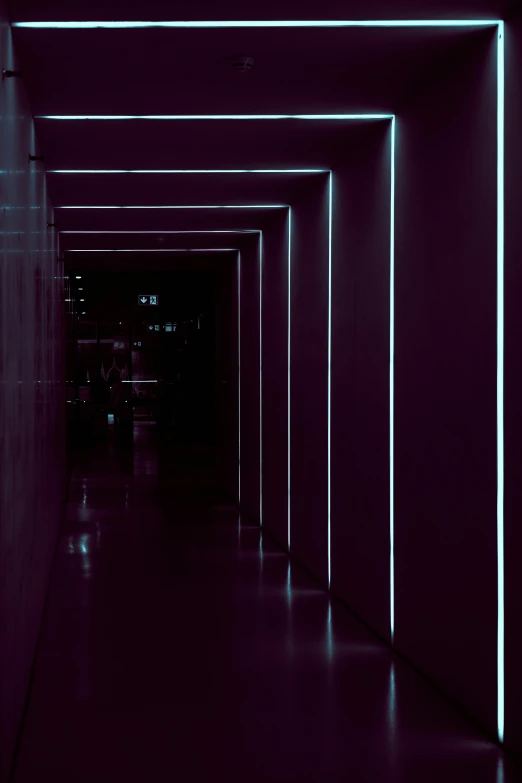 a purple hallway has a row of empty benches in it