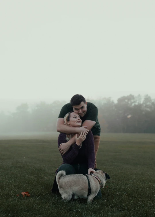 two people that are hugging each other in the grass