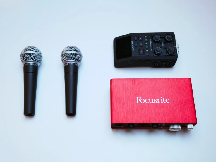 three microphones are on top of the red book