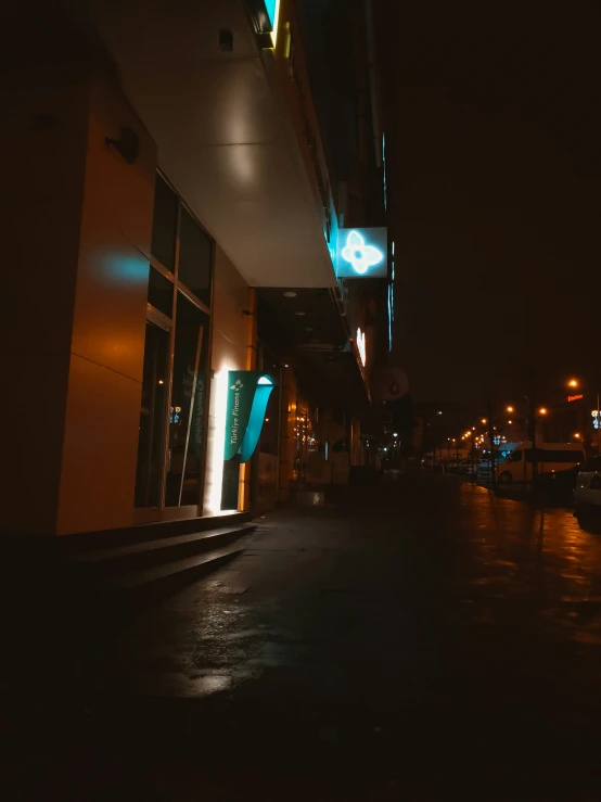 an empty alley by a building on a very dark night