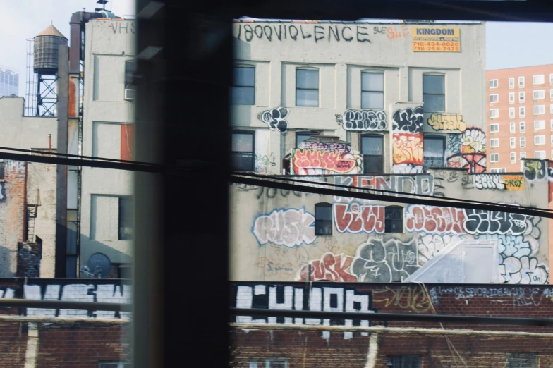 some graffiti on a building and traffic light