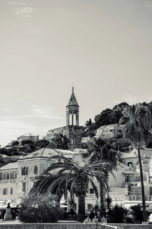 view of an old town from the water in front of a mountain