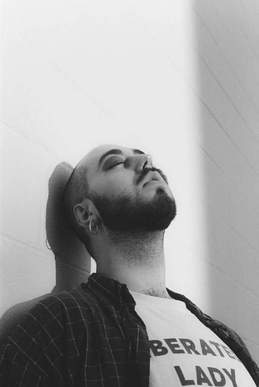 man looking upward while wearing a t shirt with liberty written on it