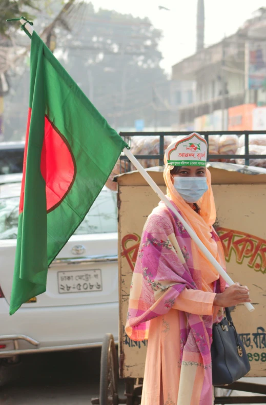 a woman with face covering standing near truck