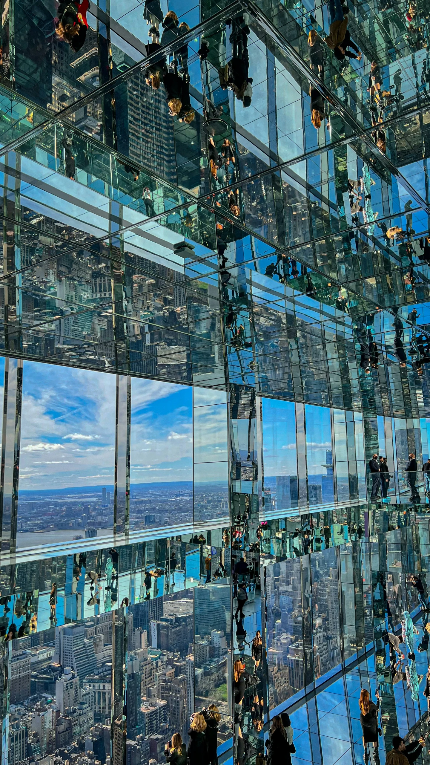 the view from inside a glass building looking out on the city