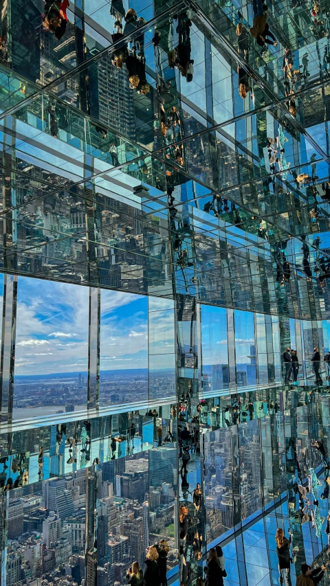 the view from inside a glass building looking out on the city