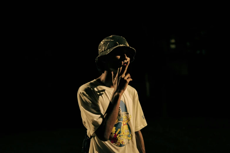 a man standing up against a dark background