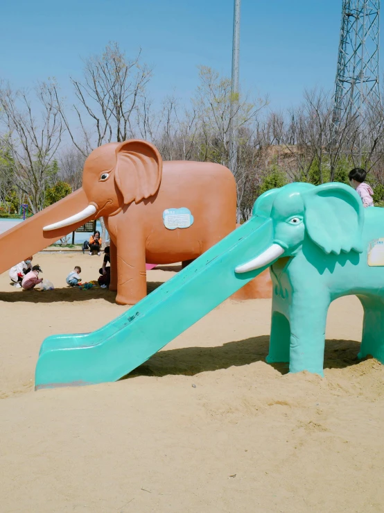 a couple of elephants are in the sand