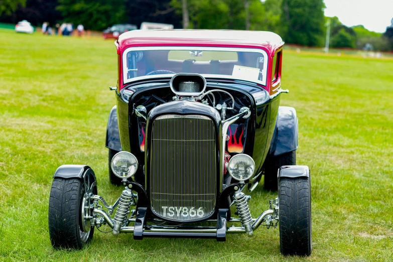 an old car with many big wheels and some lights