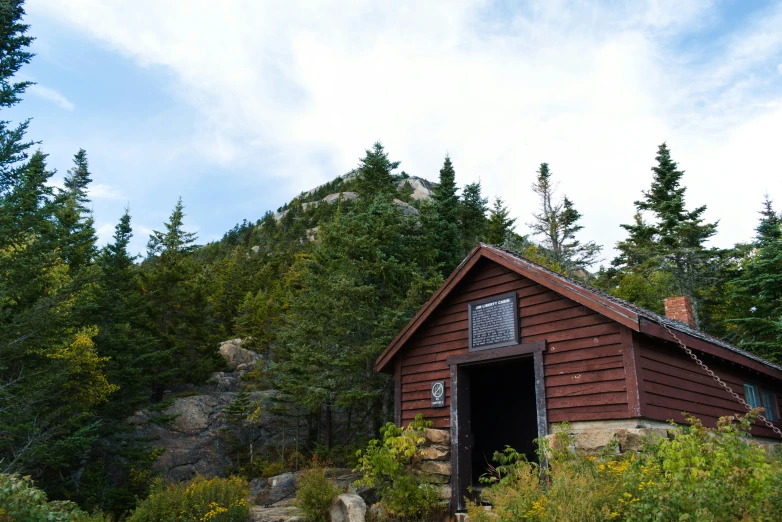 a red shed surrounded by trees and plants