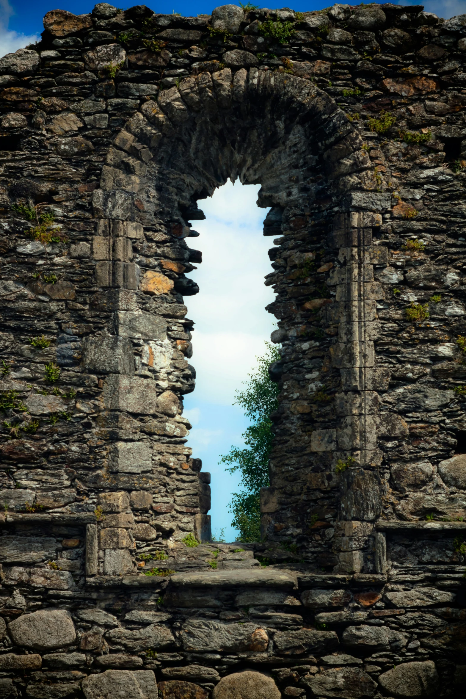 a large stone wall with a very large window