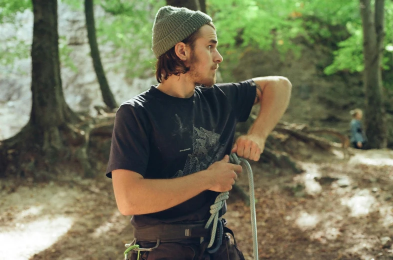 a man climbing a mountain in the woods