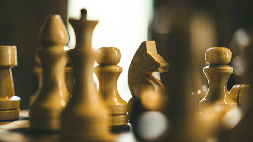 a set of chess pieces on a wooden table