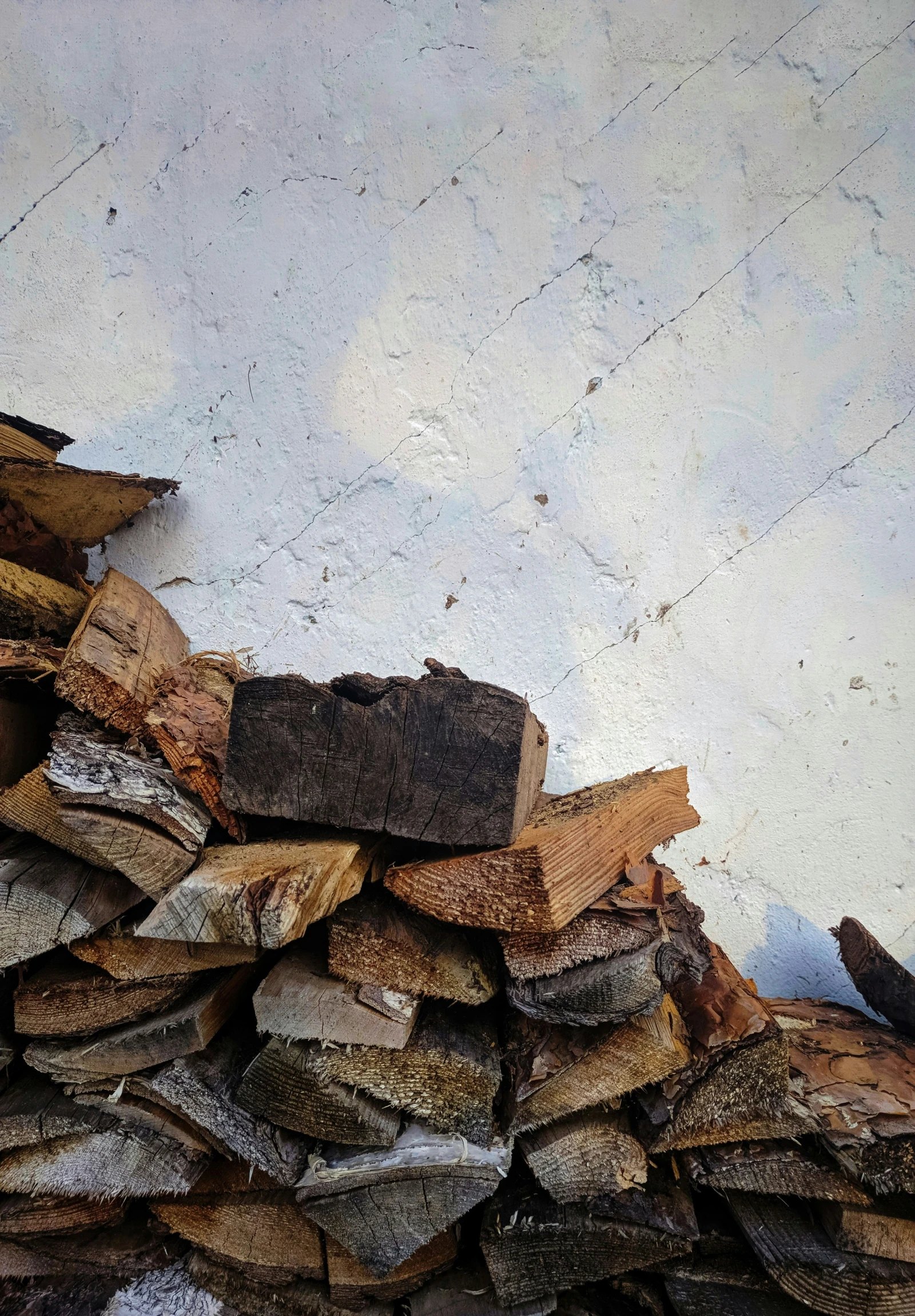 stacked firewood in front of an open fire