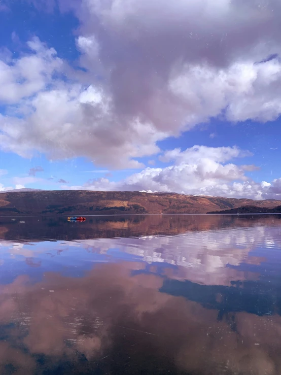 reflection in the water at a lake on a cloudy day