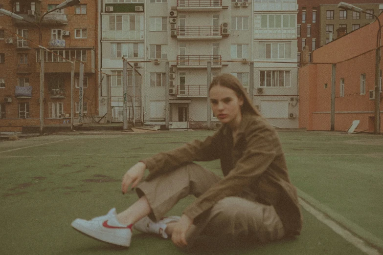 a man that is sitting down on the grass