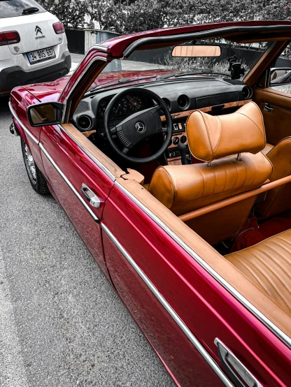 an interior view of a red car with leather seats