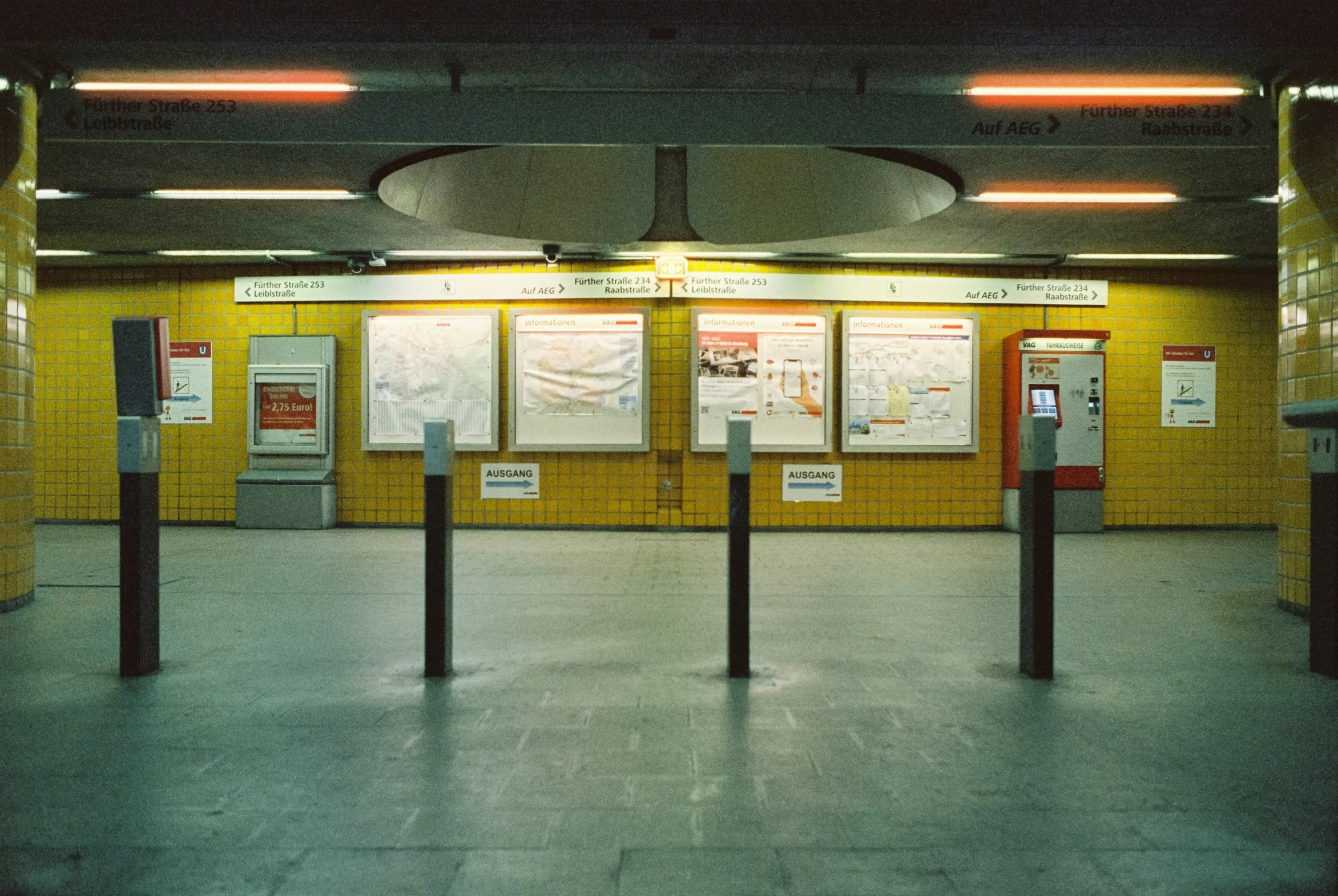 a train station with several different signs on it