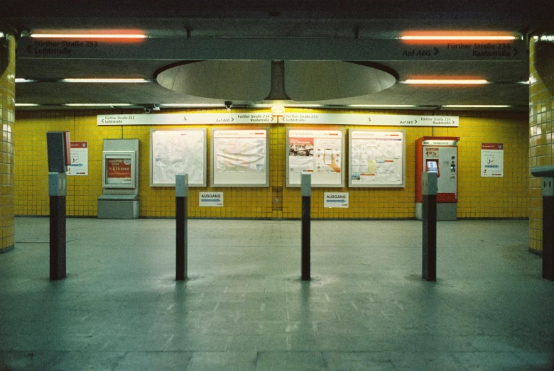 a train station with several different signs on it