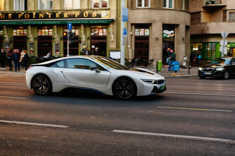 a very nice looking white car driving by itself