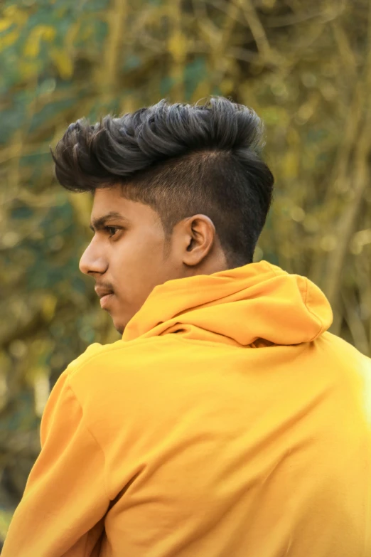 man with hooded jacket looking at the view