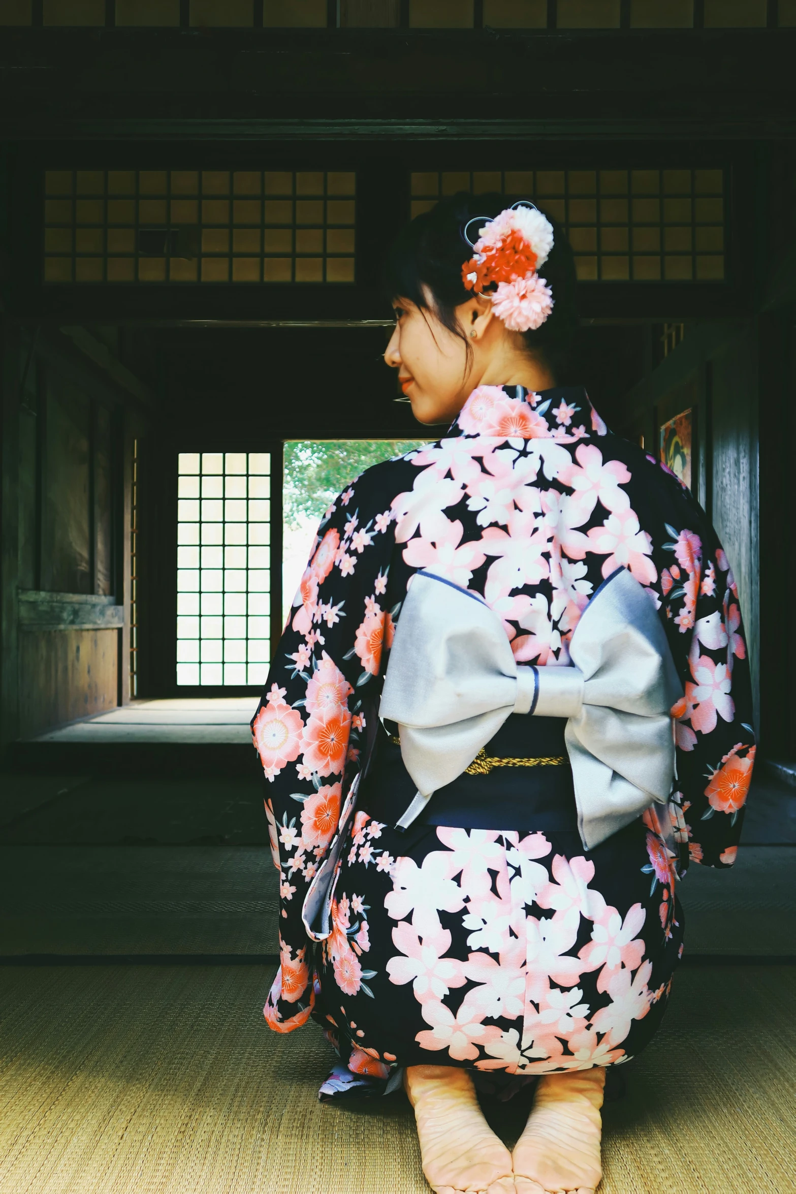 a woman in an oriental kimono waits in a doorway