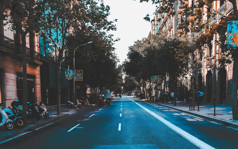 a wide open road with some buildings lining it