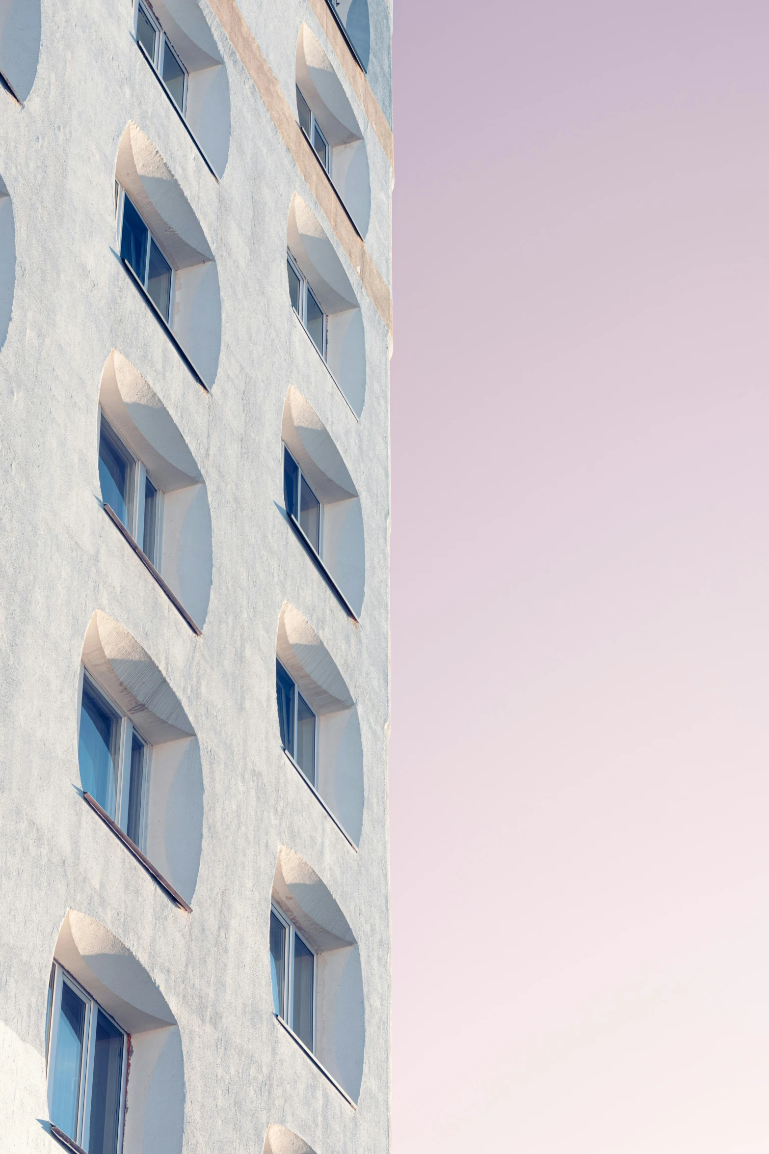 a large tall building with multiple windows and balconies