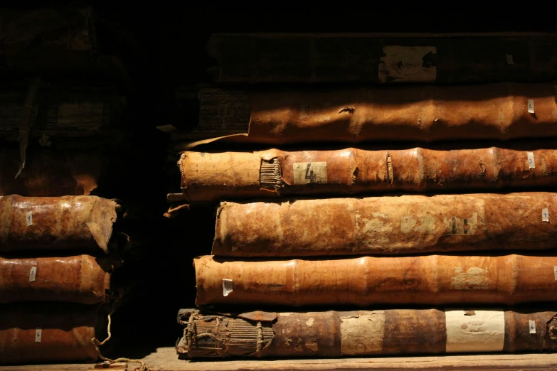 many old books stacked on top of each other