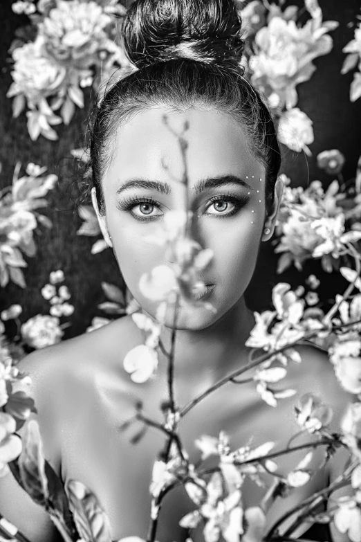 an black and white po of a young woman with a flower in her hair