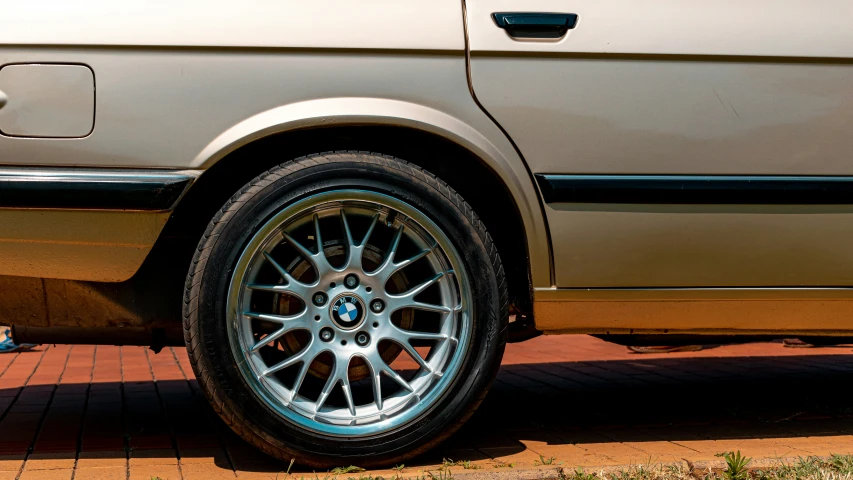 a white bmw car parked on a red brick street