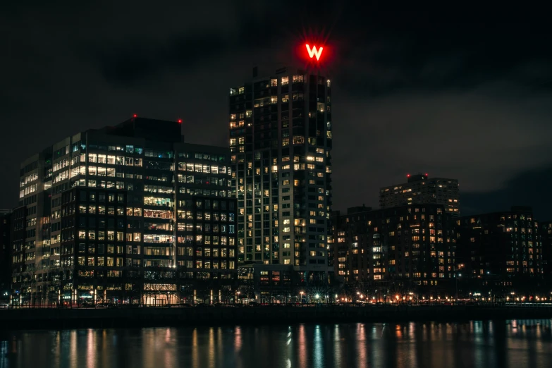 a bright red signal at the side of a building in a big city