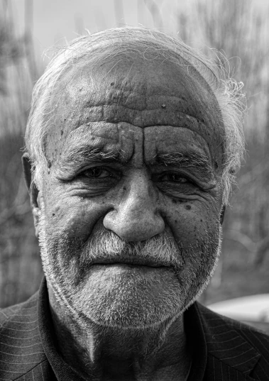 a black and white po of a man looking at the camera