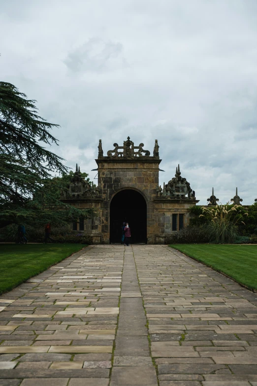 the walkway to the building is surrounded by grass