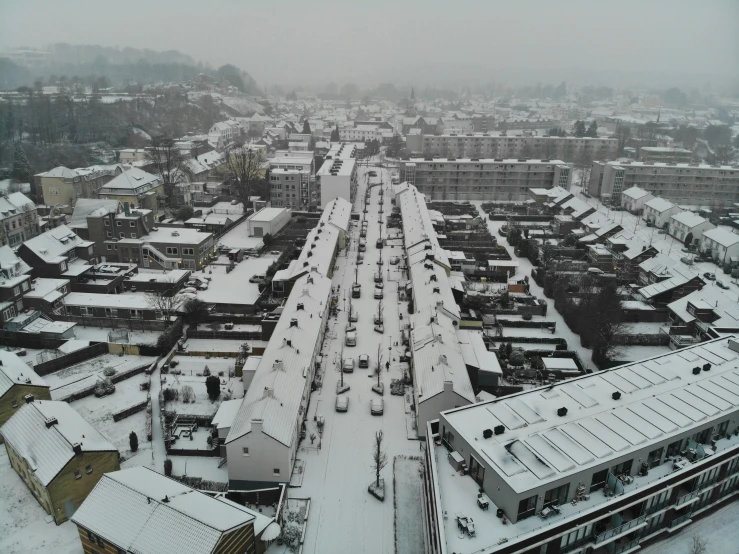 snow covered street area and buildings in city