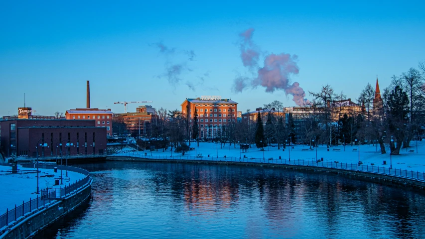 some buildings and water at dusk in the snow