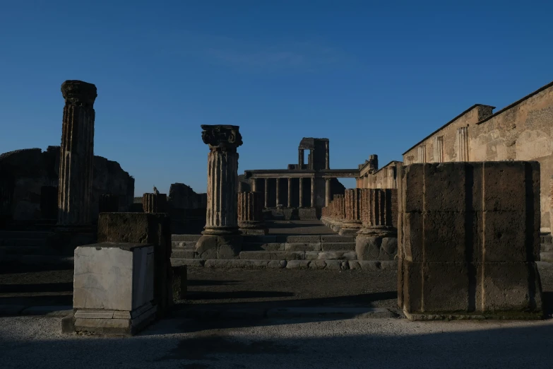 ruins and pillars stand tall with clear sky above