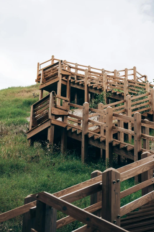 a number of stairs on a hill made from wood