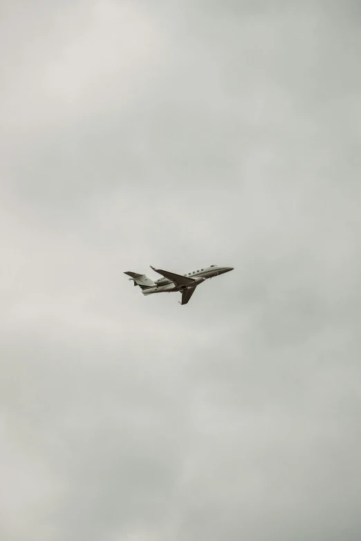 a jet flying over and a building in the background