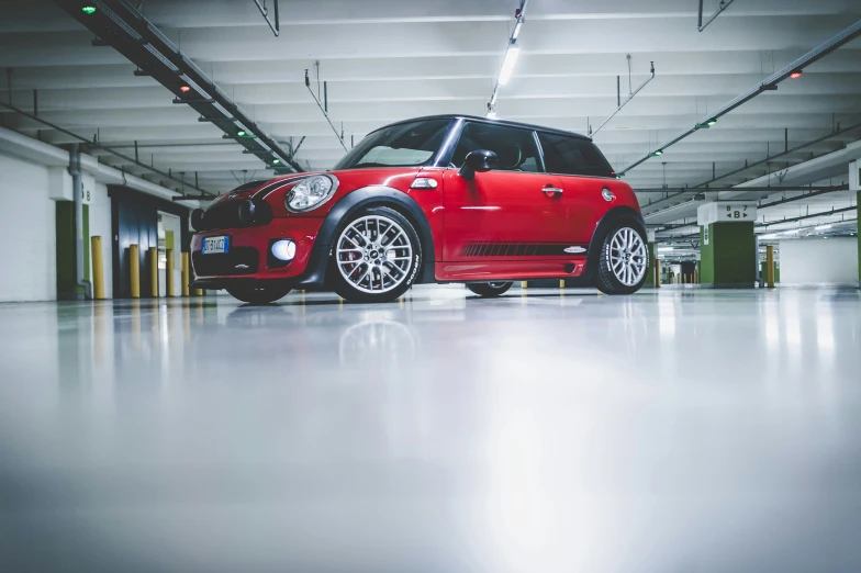 this is a small mini cooper car in a parking garage