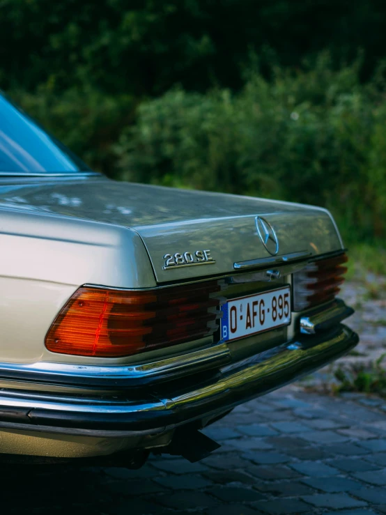 a white mercedes benz parked on the pavement