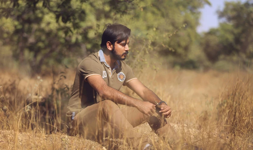 man sitting in the grass looking away