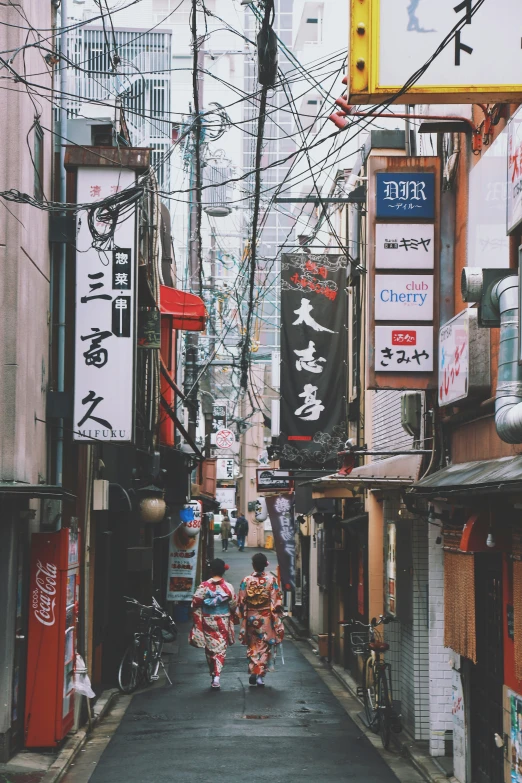 a couple of people that are standing on a street