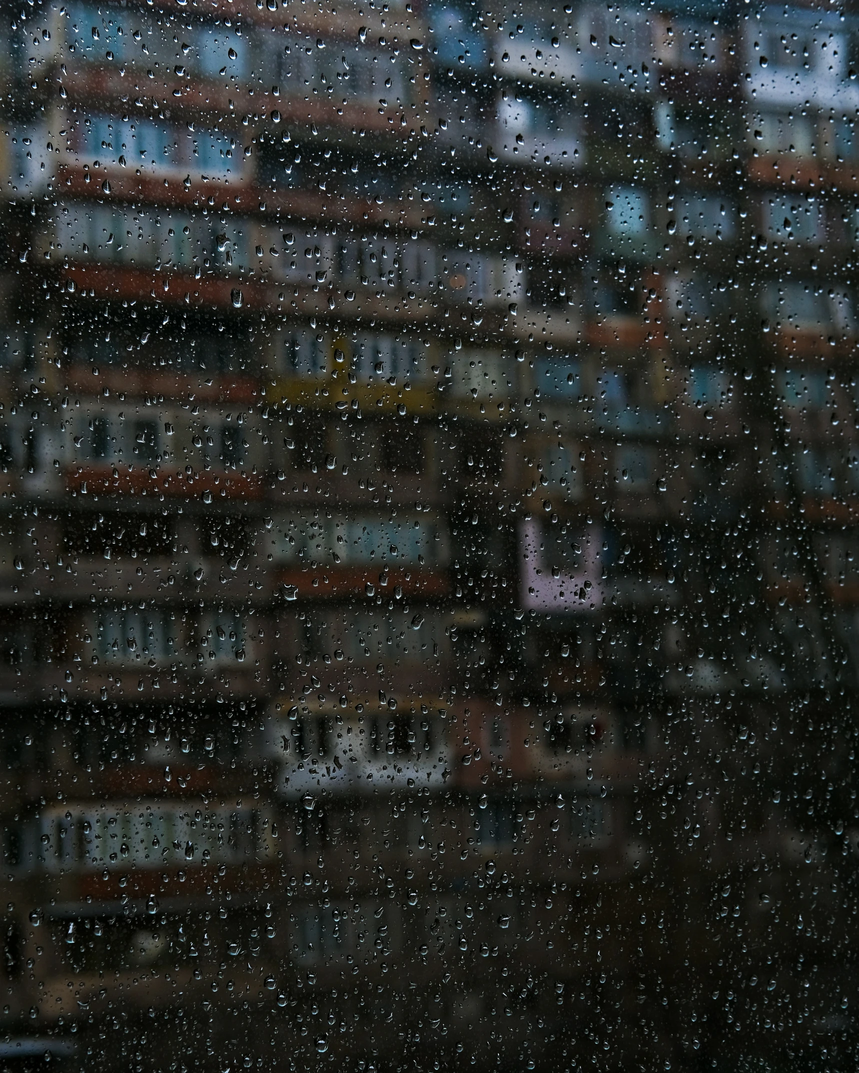 many different boxes stacked on each other near some rain