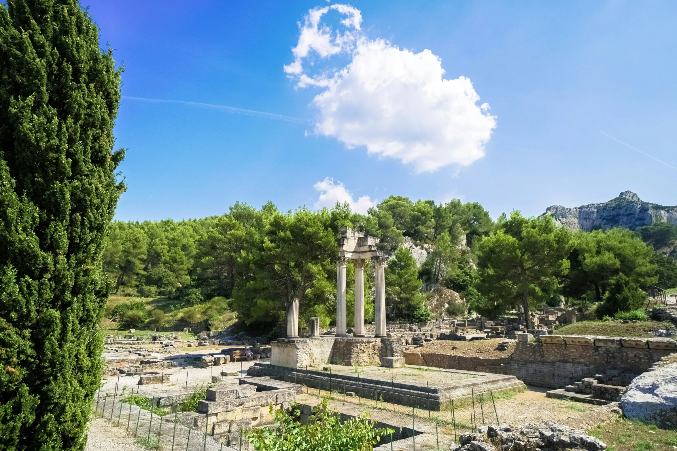 an ancient stone structure is surrounded by greenery