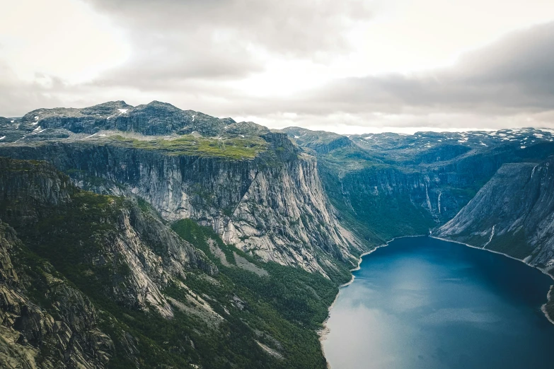 a boat traveling on a body of water surrounded by mountains