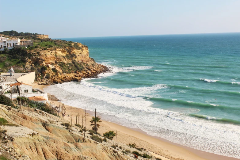 the coast and beach are lined with large, cliffs